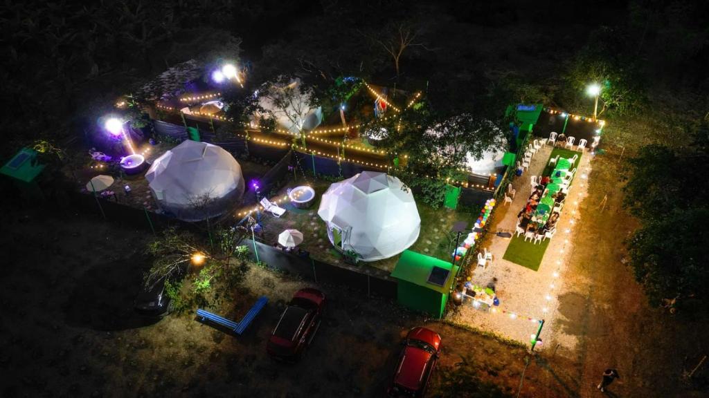 an aerial view of a park at night with lights at Paraiso Tropical Glamping in San Antonio