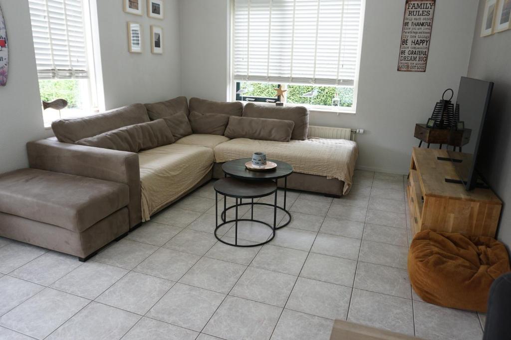 a living room with a couch and a table at Kustverhuur, Park Schoneveld, Stern 254 in Breskens