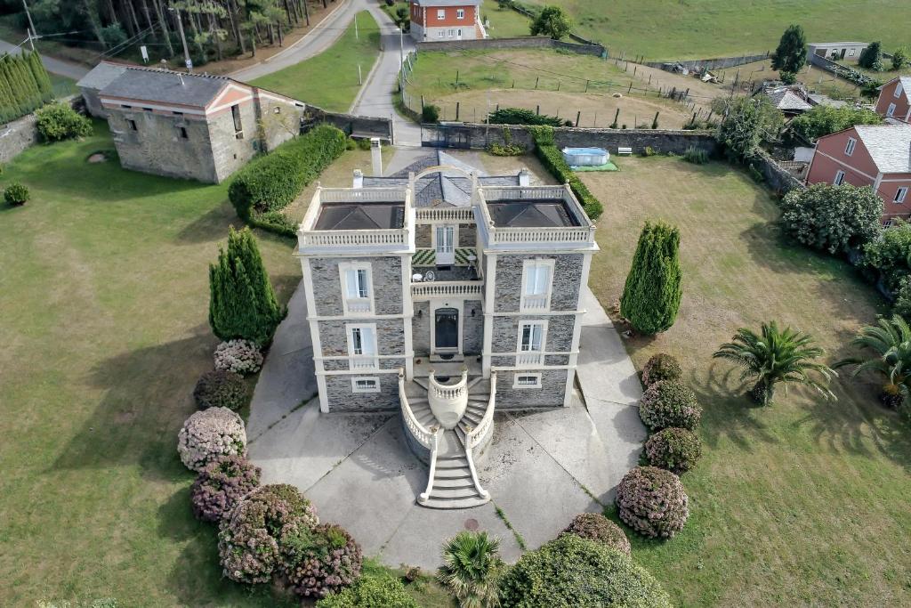 an aerial view of a large house with trees at Villa Auristela in Navia