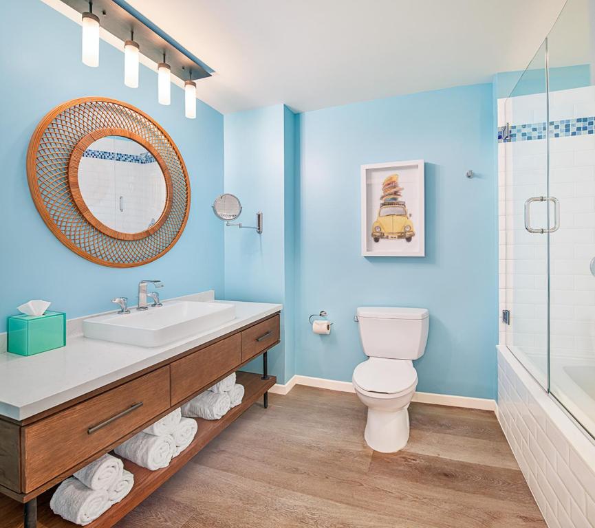 a bathroom with a sink and a toilet and a shower at Margaritaville Hotel San Diego Gaslamp Quarter in San Diego