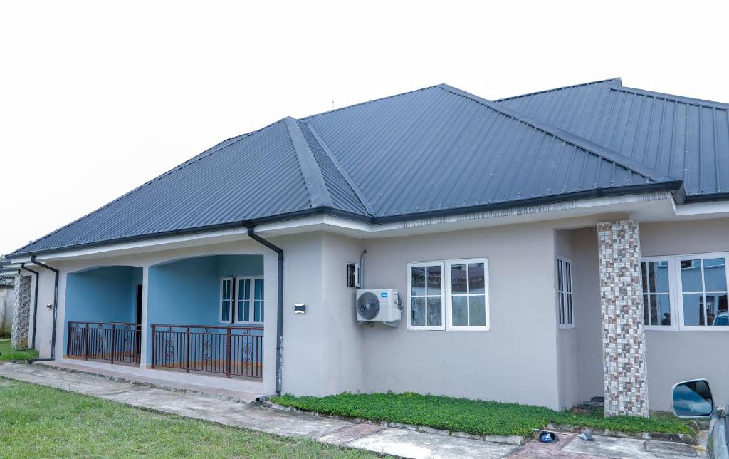 a house with a black roof at E&T Luxury Apartments in Uyo