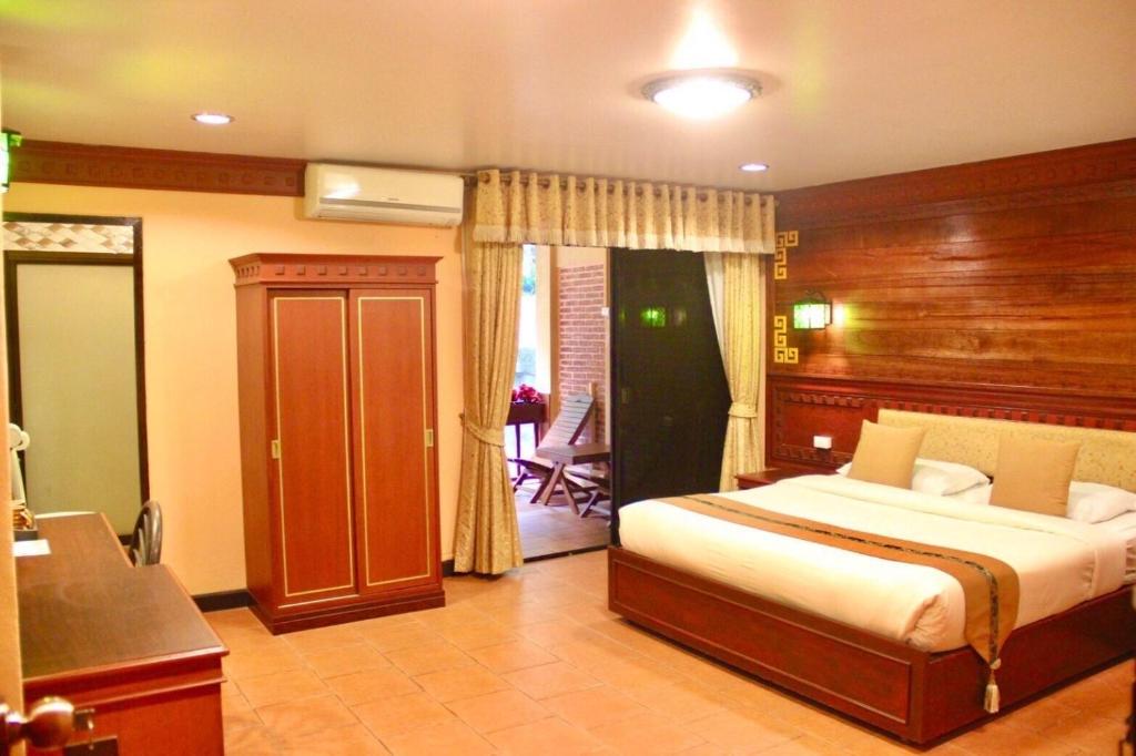 Postel nebo postele na pokoji v ubytování ดอยหมอกดอกไม้รีสอร์ท DoiMok DokMai Resort