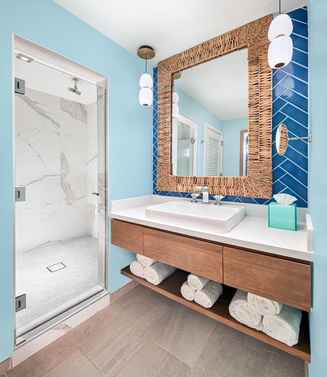 a bathroom with a sink and a mirror at Margaritaville Hotel San Diego Gaslamp Quarter in San Diego