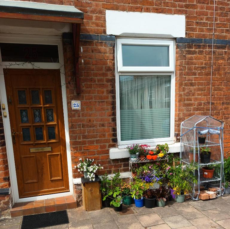 a house with a bunch of plants in front of a door at enjoy your stay in Chester