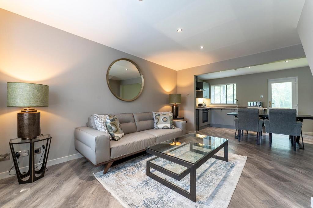 a living room with a couch and a table at 33 Dunbar Court Gleneagles Village in Auchterarder