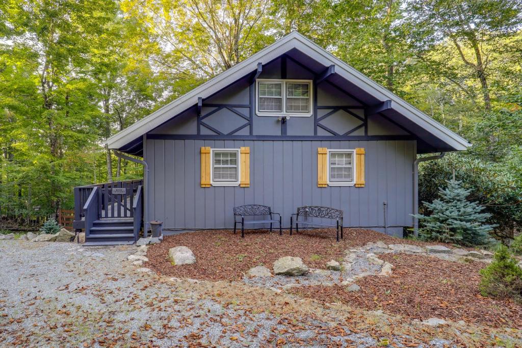 a purple house with two chairs in front of it at Pristine Cabin Less Than 2 Mi to Beech Mountain Resort! in Beech Mountain