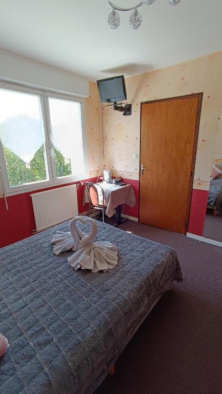 Postel nebo postele na pokoji v ubytování Hôtel Le Pommeil
