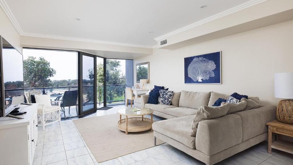 a living room with a couch and a table at On the Beach Getaway in One Mile