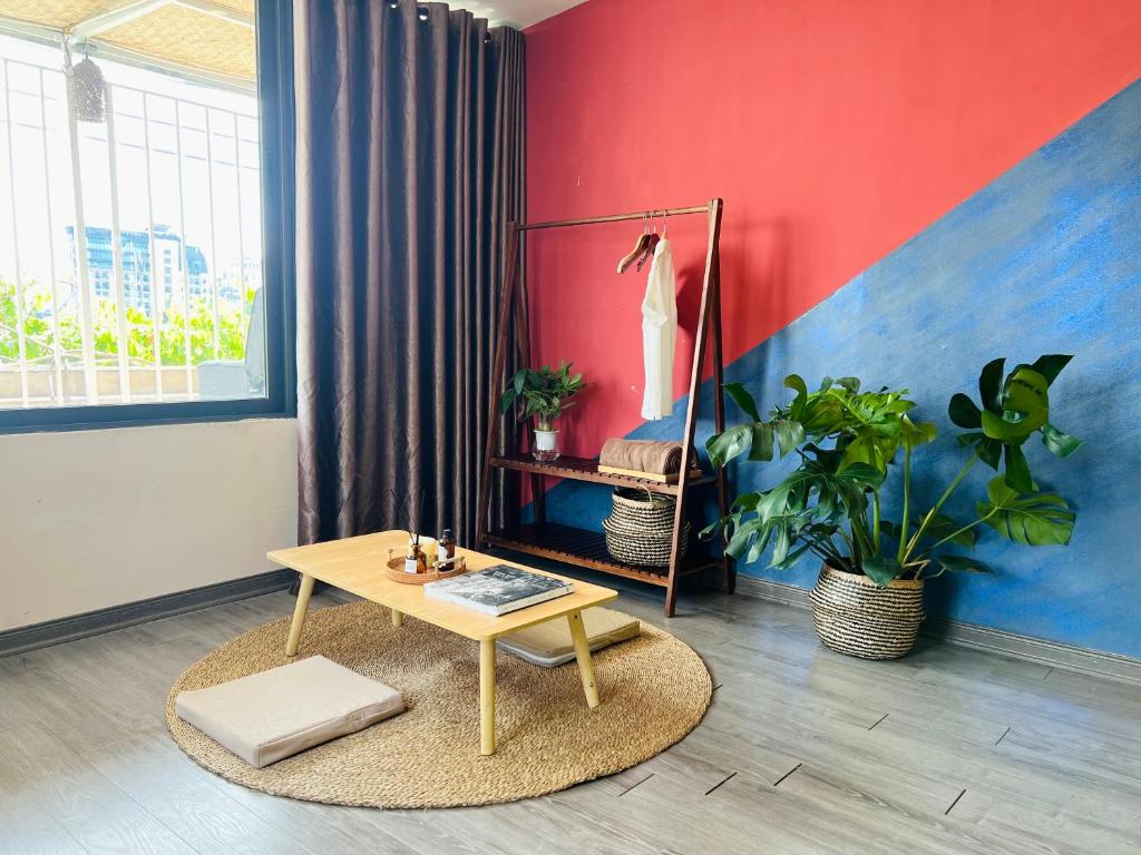 een woonkamer met een tafel en een schilderij bij 2BR/Rooftop/elevator/150m to Hoan Kiem Lake in Hanoi