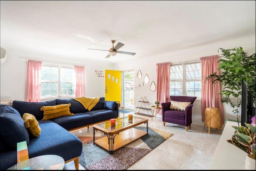 a living room with a blue couch and a table at In the Center of Gulfport, Min Away From the Beach! in St. Petersburg