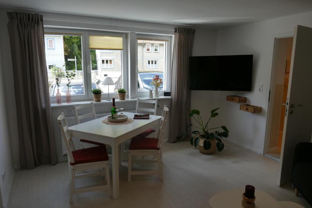 a living room with a white table and chairs at Harzapart Appartement 1 Pferdchen in Walkenried