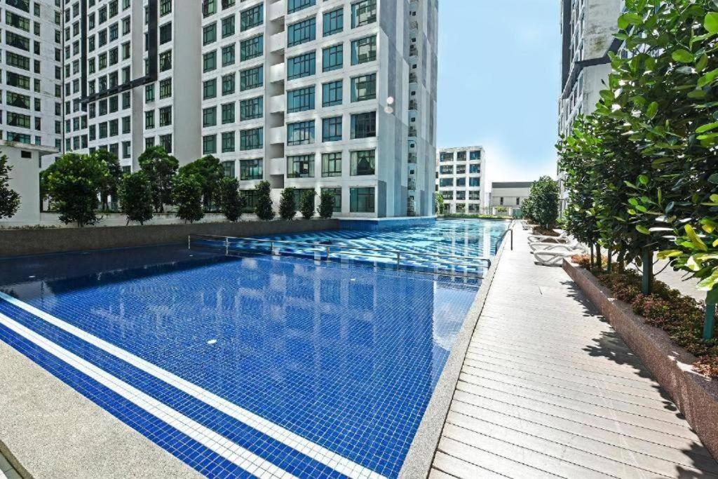 a large swimming pool in a city with tall buildings at Homestay El@sya JB-Apartment 1 bedroom in Johor Bahru
