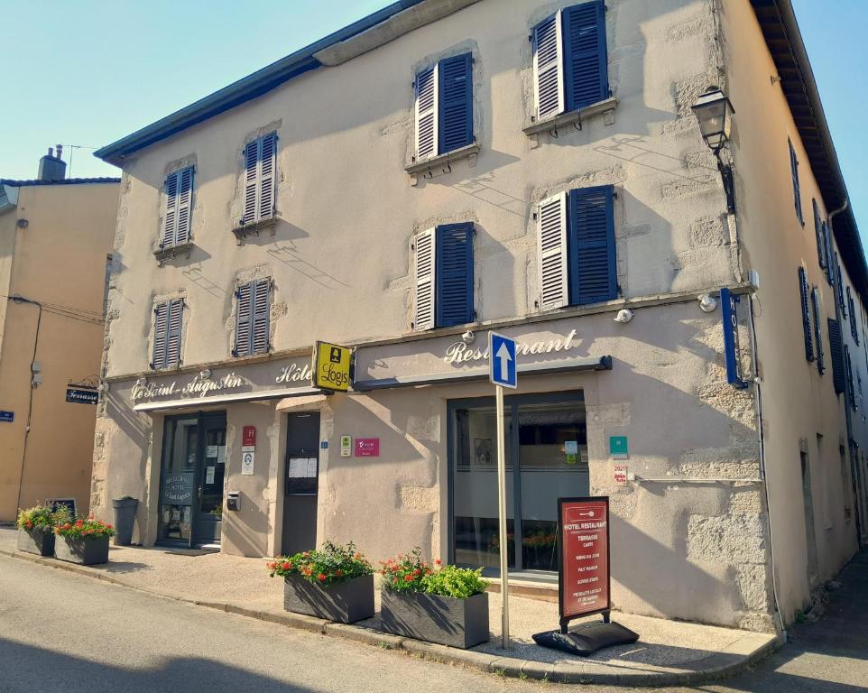 a building on the side of a street at Hôtel Restaurant LE SAINT AUGUSTIN in Saint-Amour