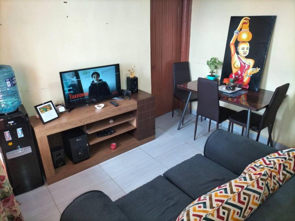 a living room with a couch and a table at Arunga's Homely Kakamega Stay in Kakamega