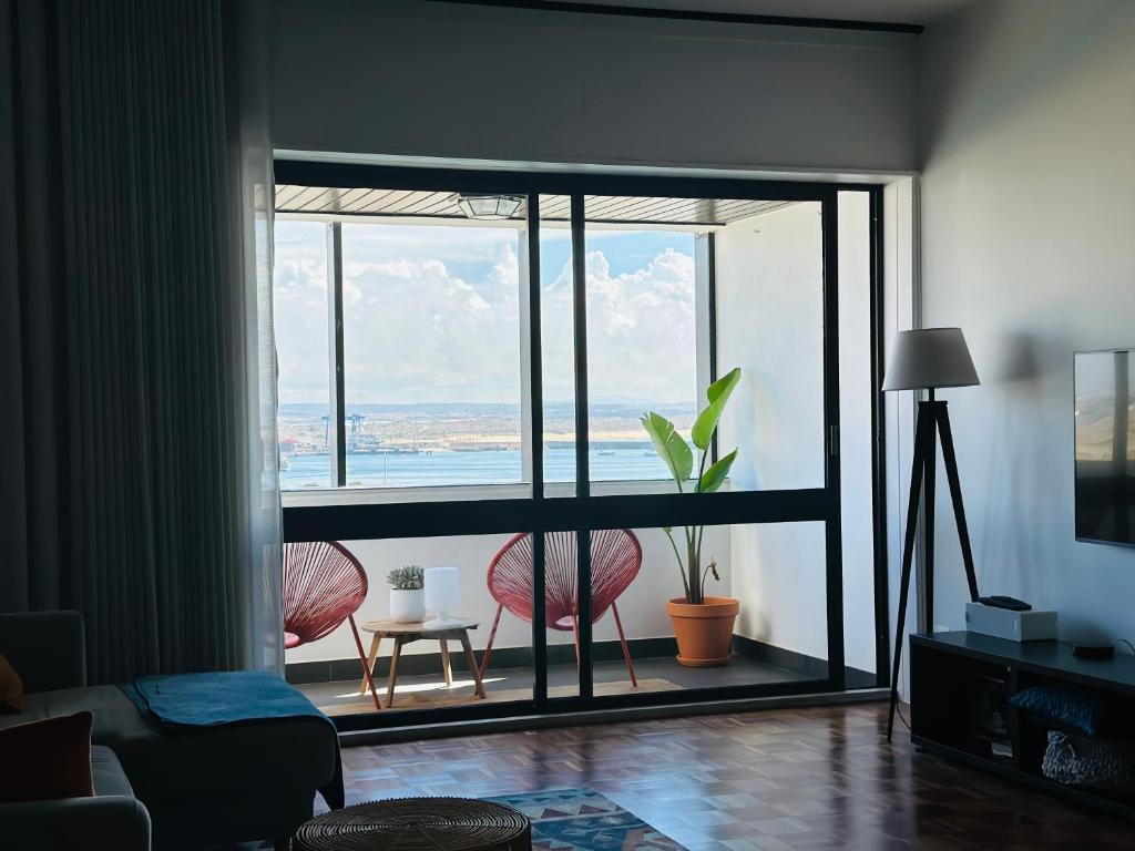 a living room with a large window with a view at Ponte Velha in Peniche