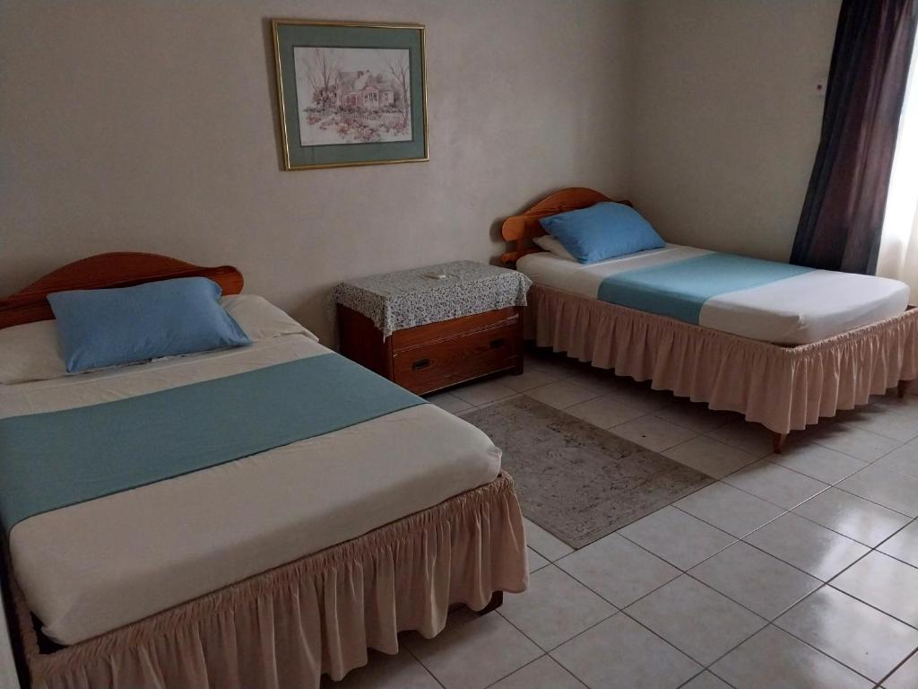 two beds sitting in a room with at Casa Villa Apartments in Calliaqua