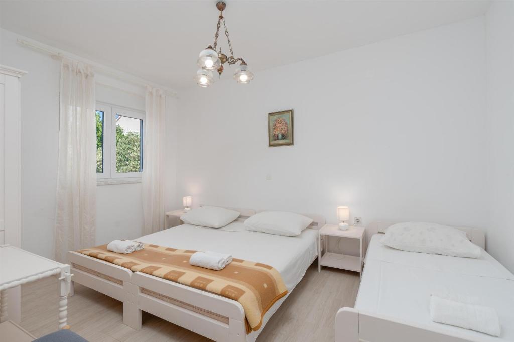 Postel nebo postele na pokoji v ubytování Apartments Family Gligora