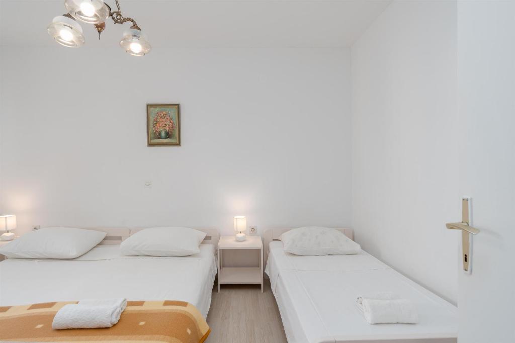 Postel nebo postele na pokoji v ubytování Apartments Family Gligora