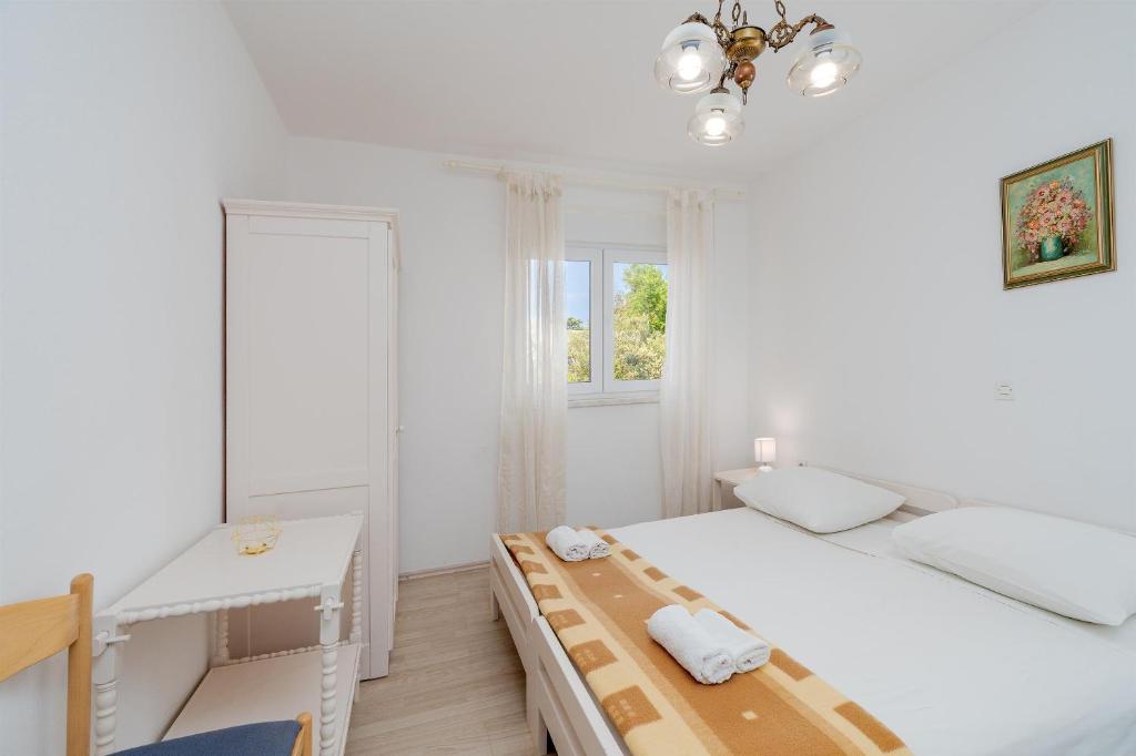 Postel nebo postele na pokoji v ubytování Apartments Family Gligora