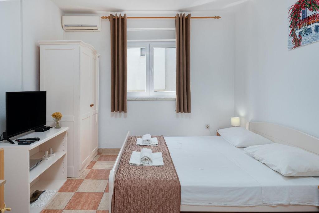 Postel nebo postele na pokoji v ubytování Apartments Family Gligora