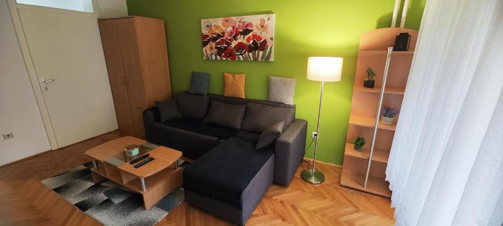 a living room with a couch and a table at Boris Apartmani Kraljevo in Kraljevo
