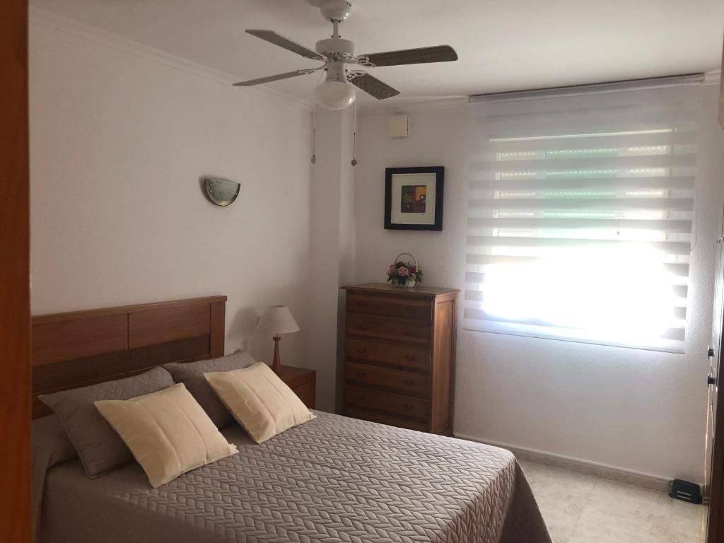 a bedroom with a bed and a ceiling fan at Paraíso in Cumbre del Sol