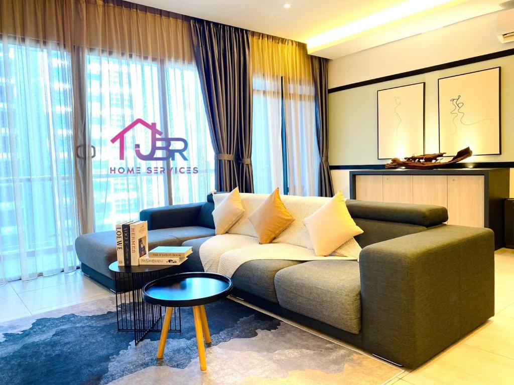 a living room with a couch and a table at JBR LUXURY HOMESTAY-ATLANTIS RESIDENCES-Near Jonker Walk-City Area-Netflix in Melaka