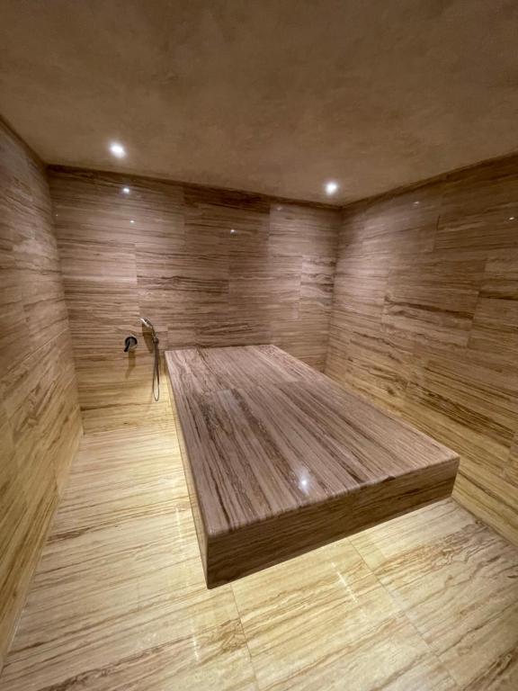 a large wooden room with a bed on a wooden floor at Villa La Falaise in Oualidia