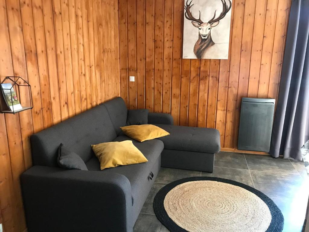 a living room with a couch and a table at Chalet La Joue du Loup, 3 pièces, 7 personnes - FR-1-504-62 in Le Dévoluy