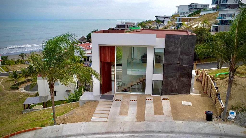 uma casa numa colina junto ao oceano em Refugio Sova em Jama