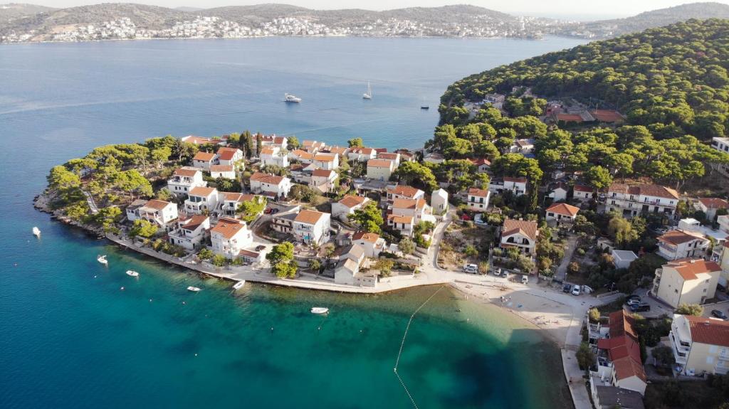 an aerial view of a small island in the water at Modern Seafront Villa Steps from the Beach in Rogoznica