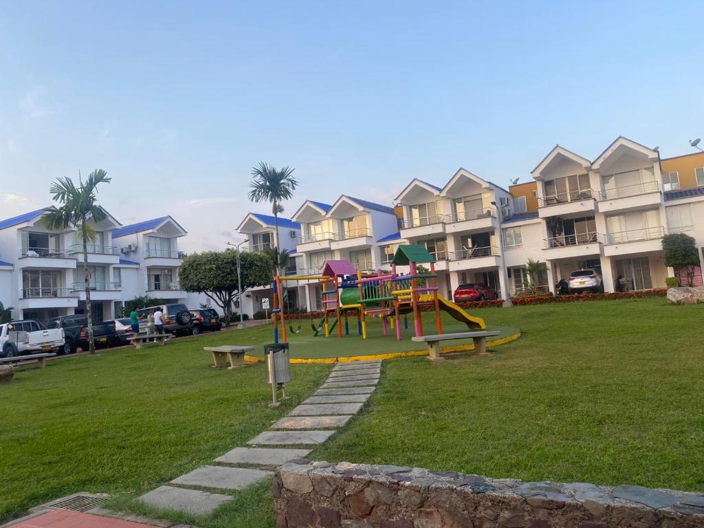 um parque com parque infantil em frente a algumas casas em CASA LUXURY em Villavicencio