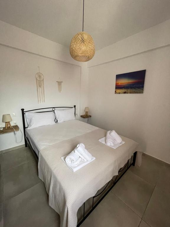 a bedroom with a bed with two towels on it at Olivar Suites in Palekastron