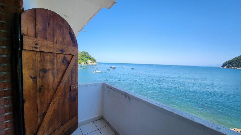 a room with a door and a view of the water at Villa frente al mar en Yelapa para 2 personas in Yelapa