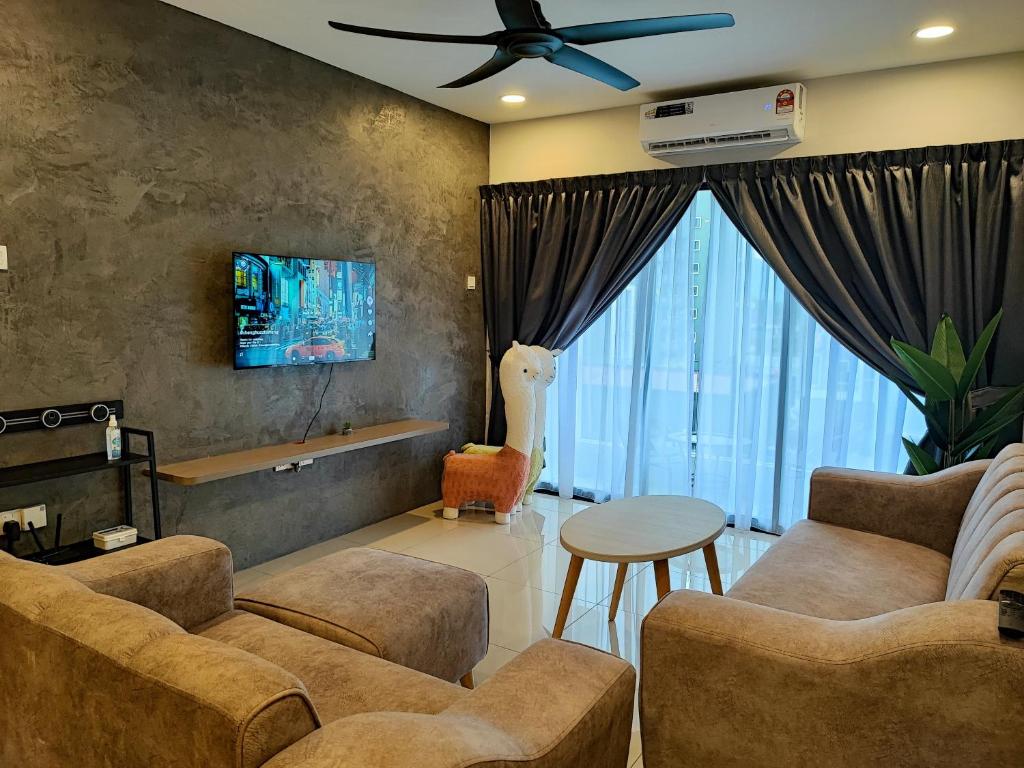 a living room with two couches and a ceiling fan at 7&9 Manhattan Condominium Ipoh in Ipoh