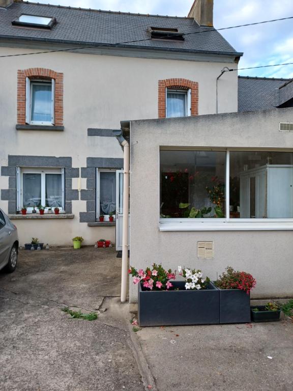 uma casa com uma janela com flores em Chez Anita em Plérin