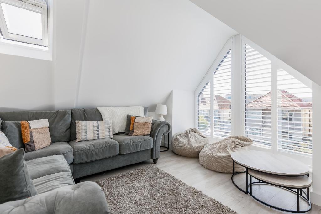 a living room with a couch and a table at 2 bed Seaside Apartment with Parking in Southbourne