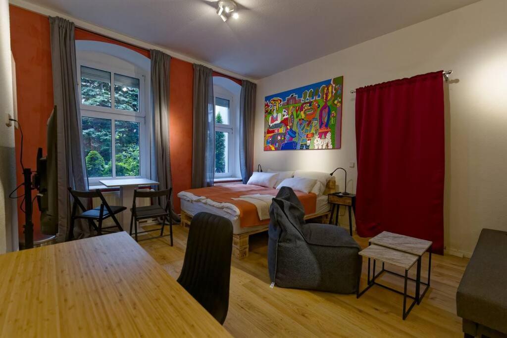 a bedroom with a bed and a table in a room at Wohnung 3 neben Warschauer Platz und Spree in Berlin