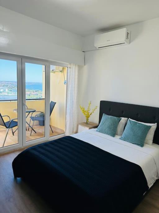 a bedroom with a large bed and a balcony at Studio with sea view in Cascais in Cascais
