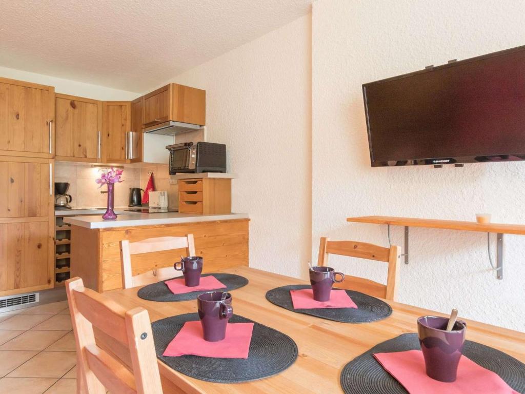 蒙熱內夫爾的住宿－Appartement Montgenèvre, 1 pièce, 4 personnes - FR-1-330D-33，带四把椅子的桌子和厨房的房间