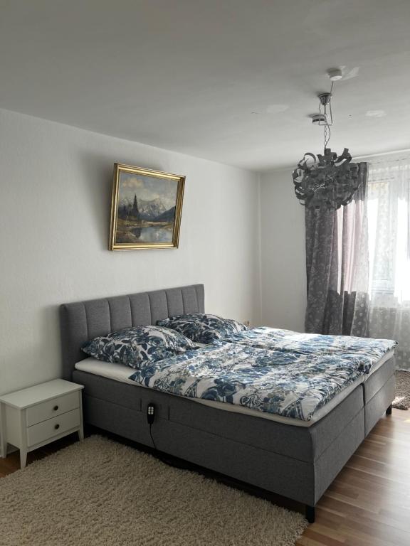 a bedroom with a bed and a picture on the wall at Schönes Zuhause in Hildesheim