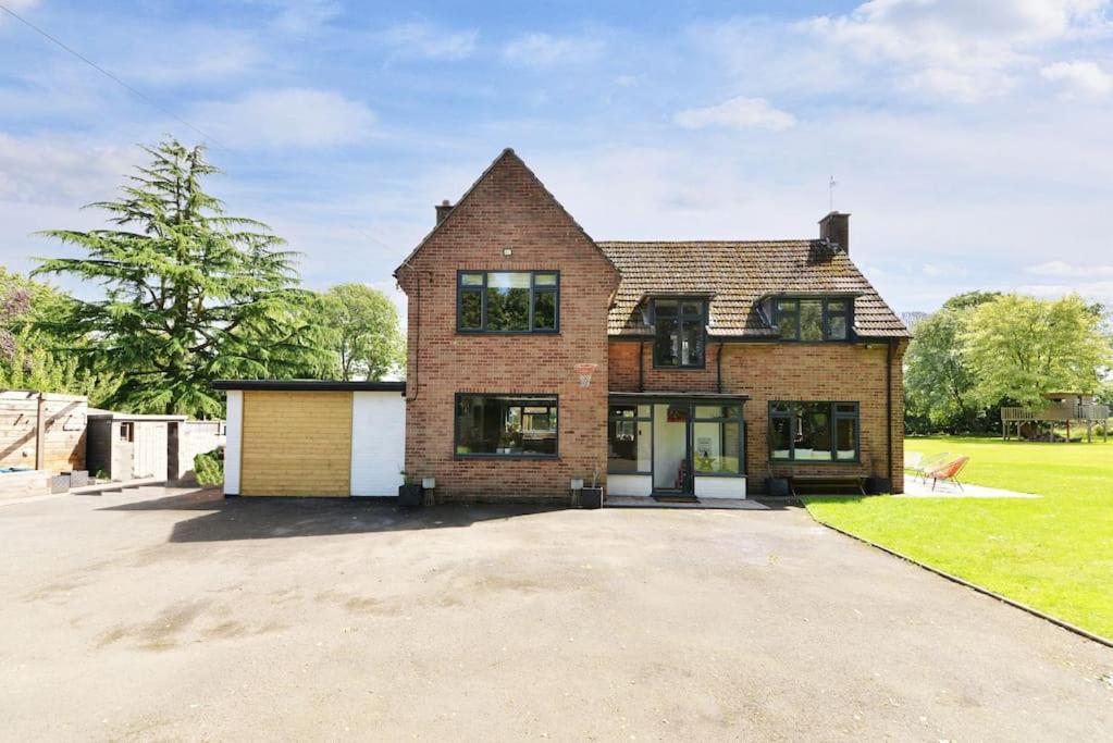 a large brick house with a garage at Stunning, high end country house in Nether Whitacre