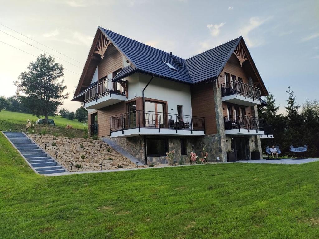 a house with a large yard in front of it at Kraina Rysia in Berezka