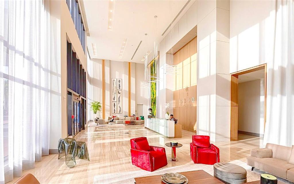 a large lobby with red chairs in a building at Doral City View in Miami