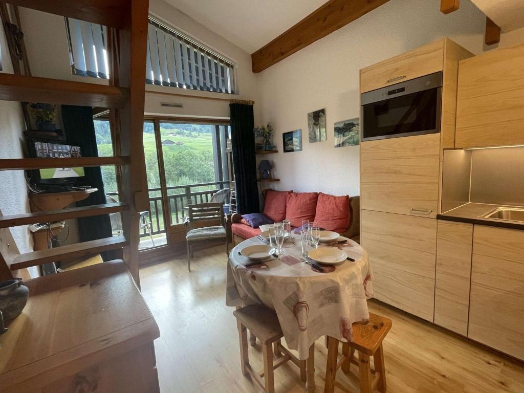 a living room with a table with wine glasses on it at Appartement Praz-sur-Arly, 2 pièces, 5 personnes - FR-1-603-13 in Praz-sur-Arly