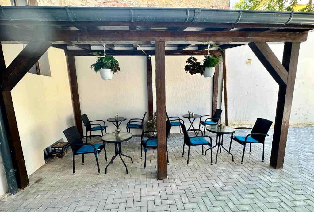 a group of tables and chairs in a patio at Stay Inn Central Brasov Apartments in Braşov