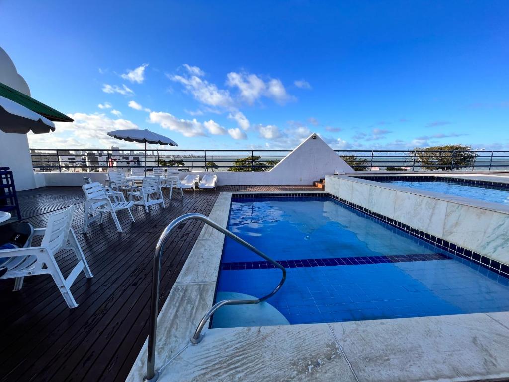 a swimming pool on the roof of a building at Flat Tambaú in João Pessoa