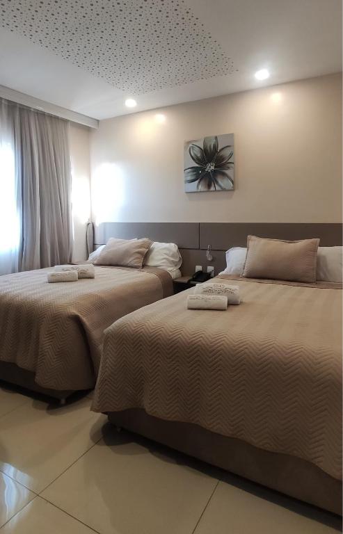 Postel nebo postele na pokoji v ubytování SERPYL Plaza Hotel