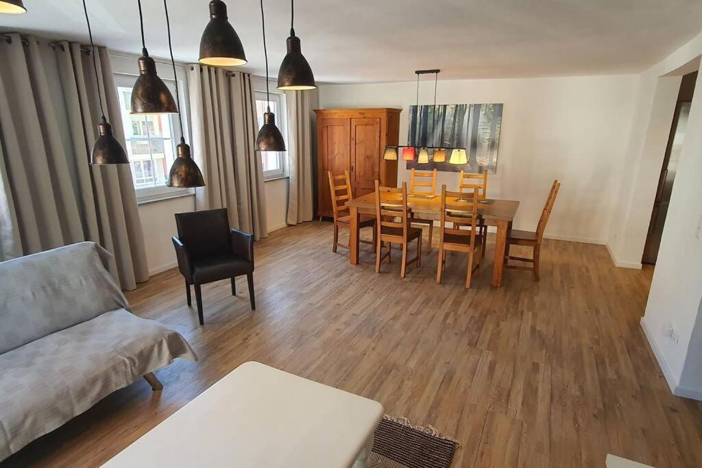 a living room with a couch and a table and chairs at Apartment Doppelhorst in Oberndorf in Oberndorf