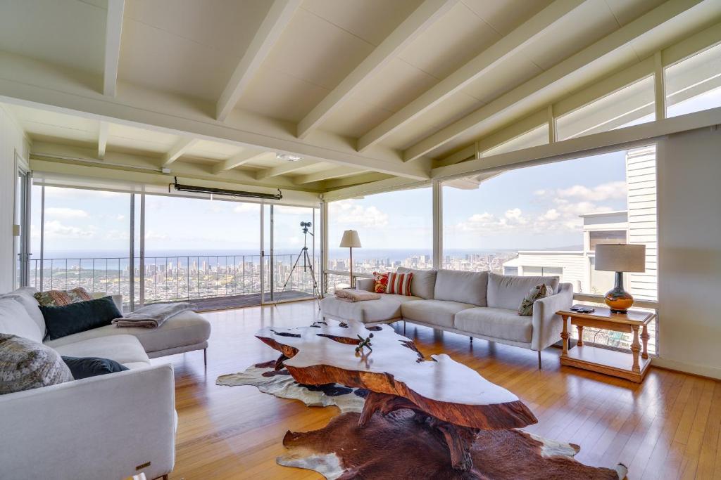 a living room with couches and a table at Breezy Honolulu Home Rental Ocean and Skyline Views in Honolulu